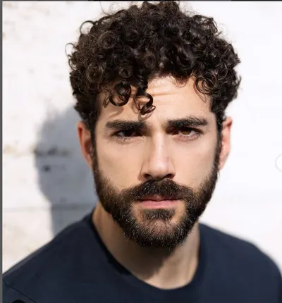 Actor Andrea Di Luigi wearing a blue T-shirt