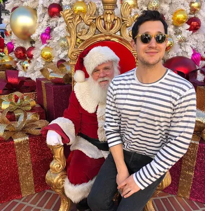 Actor Dan Levy is seen posing for a photo with Santa Claus on Christmas Day.